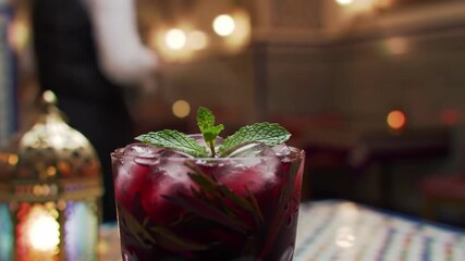 Iced fruity beverage at Moroccan restaurant with people dining in background