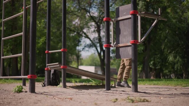 Dynamic Outdoor Fitness Jump, Bright Summer Environment With Focused Athlete Performing Explosive Jump, Male Sportsman Demonstrates Powerful Leap At Outdoor Gym Under Sunny Summer Skies