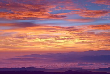 Obraz premium Pink Orange Hued Mountain Range with Sea of Clouds at Sunrise for Nature Landscape Background 
