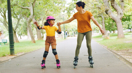 Fototapeta premium Roller skating, holding hands and mom with child in nature on holiday, getaway or weekend trip with balance. Happy, safety and mother with kid in skates for hobby together outdoor in park on vacation