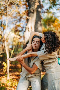 Two women performing contemporary dance in autumn forest