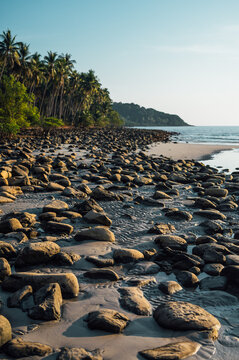 Rocky shoreline at low tide on Ao Phrao Beach, Koh Kood, Thailand