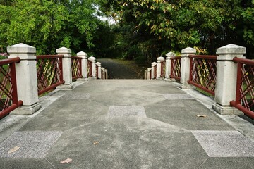 Pedestrian stone bridge in a park background