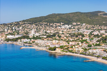 Naklejka premium La Ciotat coastal town along the Mediterranean Sea in southern France. Shoreline with residential buildings and calm blue water
