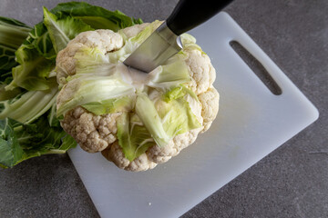 Raw cauliflower with knife, healthy cooking concept