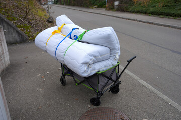 Cart with mattress strapped getting disposes at public mobile disposal facility at Swiss city of Z&uuml;rich on a foggy autumn day. Photo taken December 15th, 2025, Zurich, Switzerland.