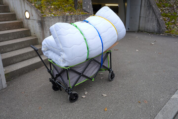 Cart with mattress strapped getting disposes at public mobile disposal facility at Swiss city of Z&uuml;rich on a foggy autumn day. Photo taken December 15th, 2025, Zurich, Switzerland.