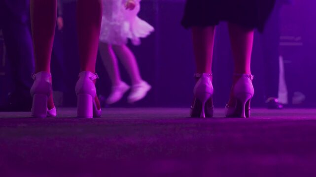 Vivid dance scene, Lively nightclub depiction showing women moving to vibrant beats, Dynamic scene of women dancing intensely in brightly lit neon nightclub filled with smoke and lively atmosphere