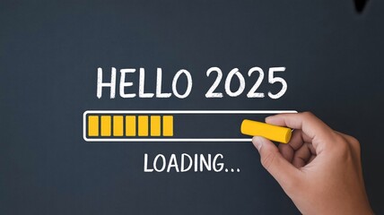 Hand holding yellow chalk writing hello 2025 on dark background with loading progress bar