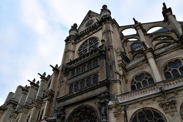 Low angle view of the magnificent facade of Saint-Eustache Church in Paris, France, showcasing Gothic and Renaissance architecture.