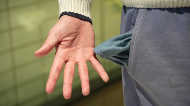 Young man shows empty pant pocket