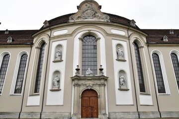 Symmetrical facade of the historic Abbey Cathedral of Saint Gall in St. Gallen, Switzerland, a World Heritage site known for its magnificent Baroque architecture with statues and ornate details