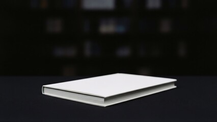 Single white book on dark background.