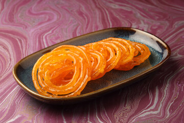 Sweet Jalebi, a popular Indian dessert, golden spirals of fried batter soaked in syrup.