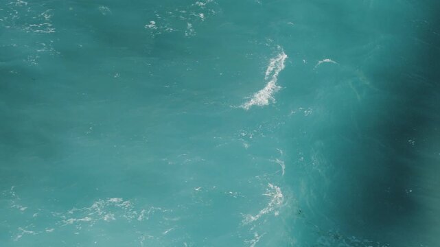 Aerial view of the mesmerizing turquoise sea, where gentle waves create a symphony of motion and texture, showcasing the ocean's vibrant beauty, Ksamil, Qarku i Vlores, Albania.