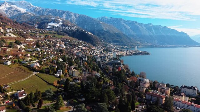 Aerial view of Montreux showing the city nestled between the lake and snow-capped mountains, a captivating blend of urban and natural beauty, Montreux, Vaud, Switzerland.