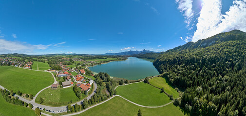 aerial photo of the alpine landscape at lake Weissensee and village of Oberkirch in the eastern Allgaeu near city of Fuessen, Bavaria, Germany
