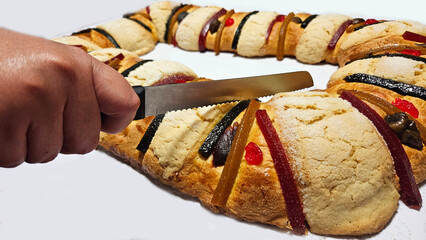 Rosca de Reyes is a traditional sweet bread decorated with crystallized fruits and hidden figures...