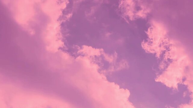 Beautiful purple sunset sky fluffy colored pink lilac clouds in sunlight fast time lapse, airplane window view, aerial drone view. Amazing evening scyscraper colorful cloudscape color atmosphere sky. 