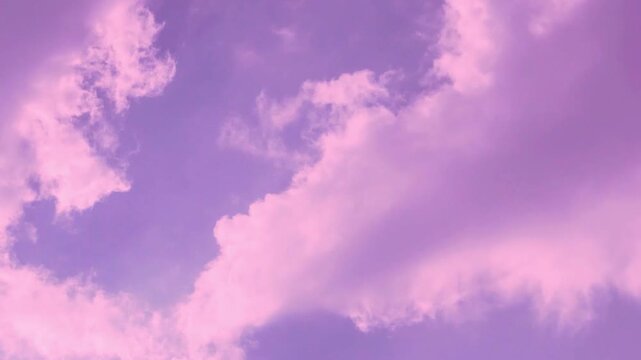 Colorful evening purple sky puffy lilac clouds in sunlight fast time lapse, airplane window view, aerial drone view. Beautiful scyscraper colored cloudscape, color atmosphere, sunrise sky cloud sun. 