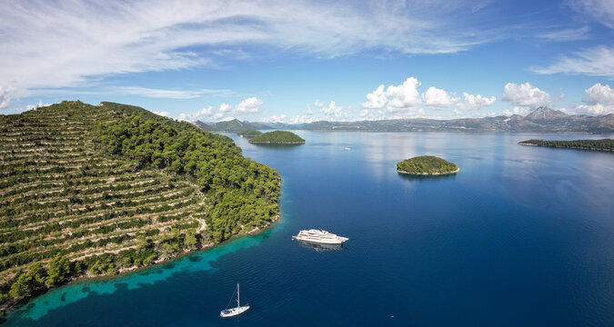Aerial view of a lush island with terraced vineyards cascading down its slopes into the azure sea, Sipanska Luka, Dubrovnik-Neretva County, Croatia.