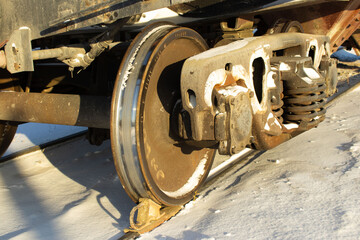 Heavy Steel Train Wheels and Bogie Suspension on Snowy Tracks