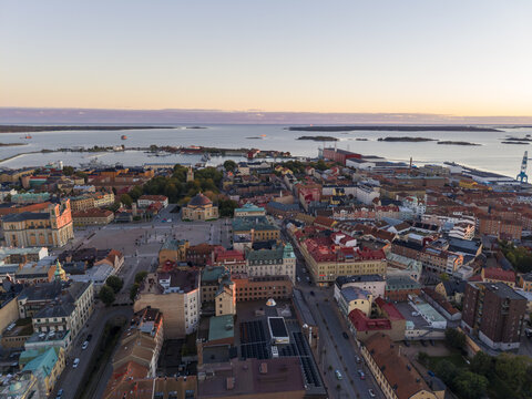 Aerial view of Stortorget square and Fredrikskyrkan church bask in the warm glow of the setting sun, casting long shadows across the cityscape, Karlskrona, Blekinge County, Sweden.