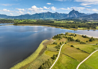aerial photo of the alpine landscape at lake Hopfensee in the eastern Allgaeu near city of Fuessen, Bavaria, Germany 