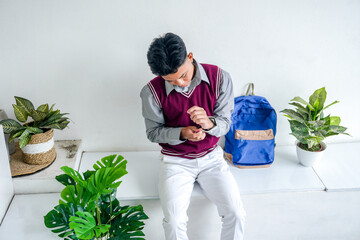 Portrait Of Young Asian Student Male Preparing Going To School With Wearing Smartwatch