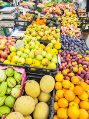 Fresh organic fruits and vegetables on farmers market stall close up.