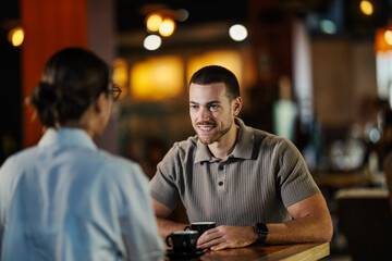 Happy man having coffee with woman in cafe