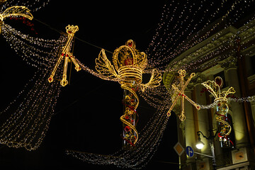 Golden Crowned Holiday Lights Adorning a Night Street