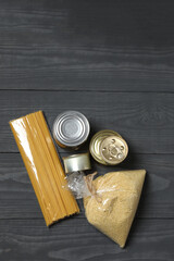 Humanitarian aid. Different food products for donation in crate on wooden table