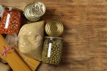 Humanitarian aid. Different food products for donation in crate on wooden table