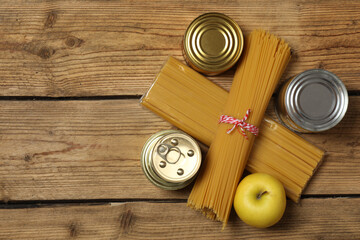 Humanitarian aid. Different food products for donation in crate on wooden table