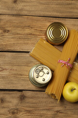 Humanitarian aid. Different food products for donation in crate on wooden table