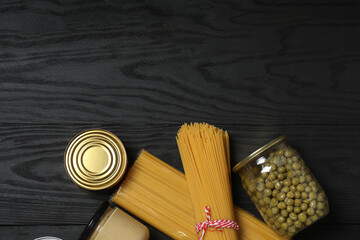 Humanitarian aid. Different food products for donation in crate on wooden table