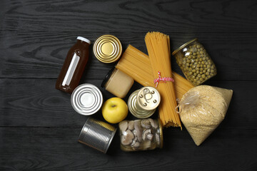 Humanitarian aid. Different food products for donation in crate on wooden table