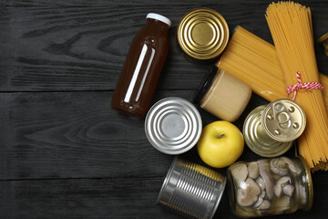 Humanitarian aid. Different food products for donation in crate on wooden table