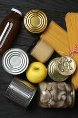 Humanitarian aid. Different food products for donation in crate on wooden table
