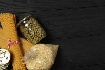 Humanitarian aid. Different food products for donation in crate on wooden table
