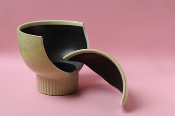 broken vase on color background

