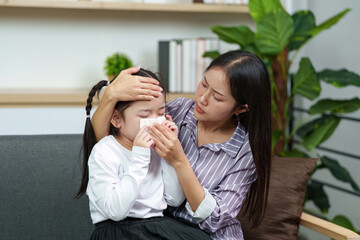 Mother Checking Temperature of Sick Daughter