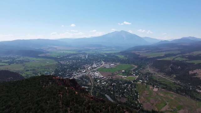 Rugged foreground terrain with sprawling valley neighborhoods and majestic snow-tinged Mount Sopris in distance, Carbondale Colorado
