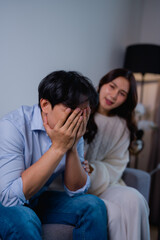 Fototapeta premium Woman comforting crying man experiencing sadness and despair