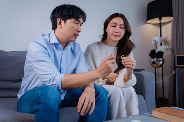 Couple contemplating relationship problems holding wedding rings