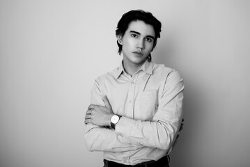 Handsome young man in smart casual attire wearing metal wrist watch