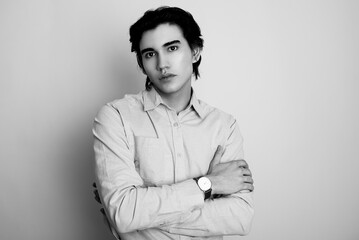 Handsome young man in smart casual attire wearing metal wrist watch