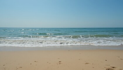 A clear horizon, soft waves, and a sandy beach backdrop