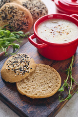 Gourmet Liver Pate Appetizer with Sesame Seed Bagels and and Fresh Pea Shoots on Rustic Wooden Board